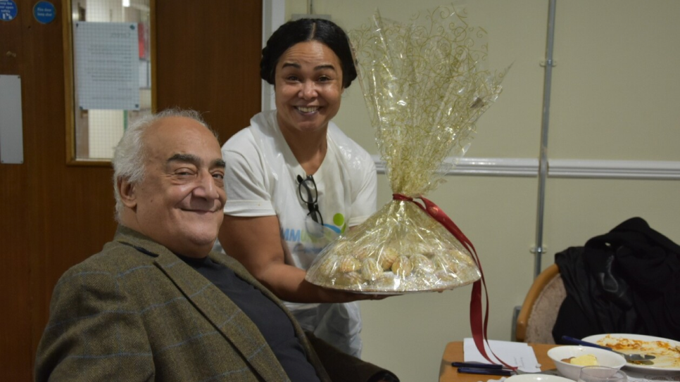 Two residents smiling with a hamper